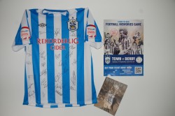Signed shirt takes pride of place on the office wall 