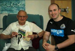 Joe with his memorabilia sharing his memories with Project Coordinator, Gavin Ferry 